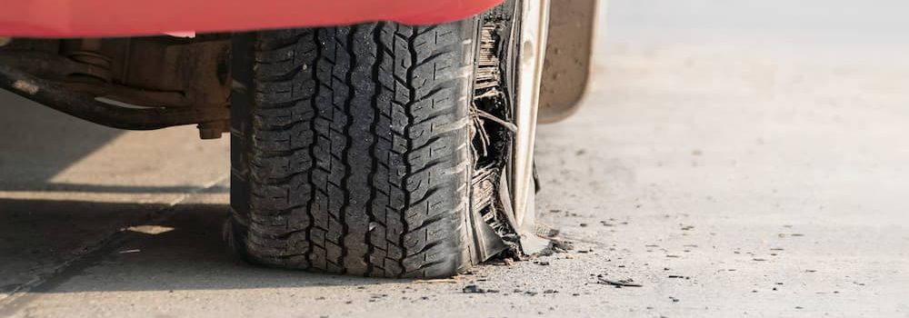 red car with blow out tyre